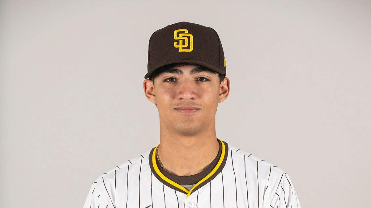 Humberto Cruz wearing San Diego Padres uniform posing at Peoria Sports Complex