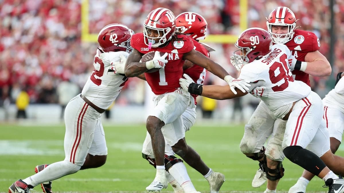 Roman Hemby running with the ball during a football game at Rose Bowl Stadium