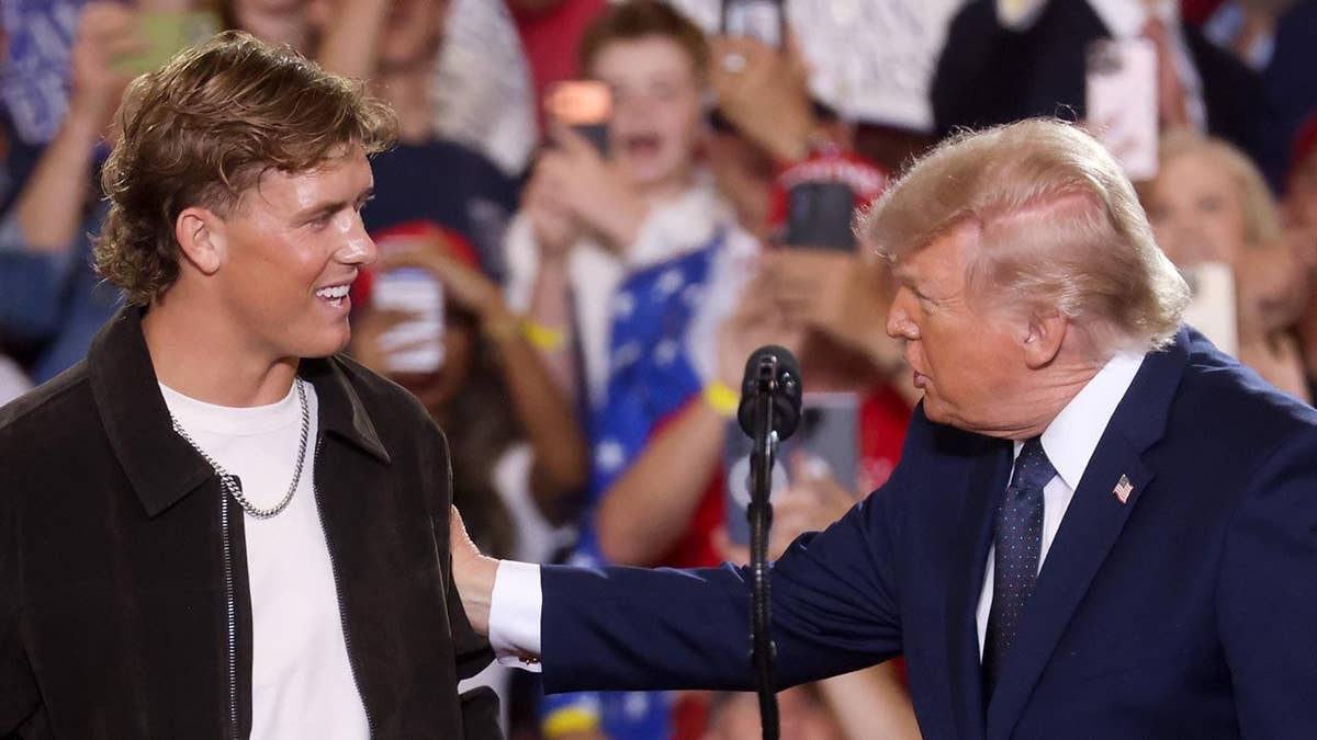 New York Giants quarterback Jaxson Dart and President Donald Trump speaking inside Eugene Levy Fieldhouse