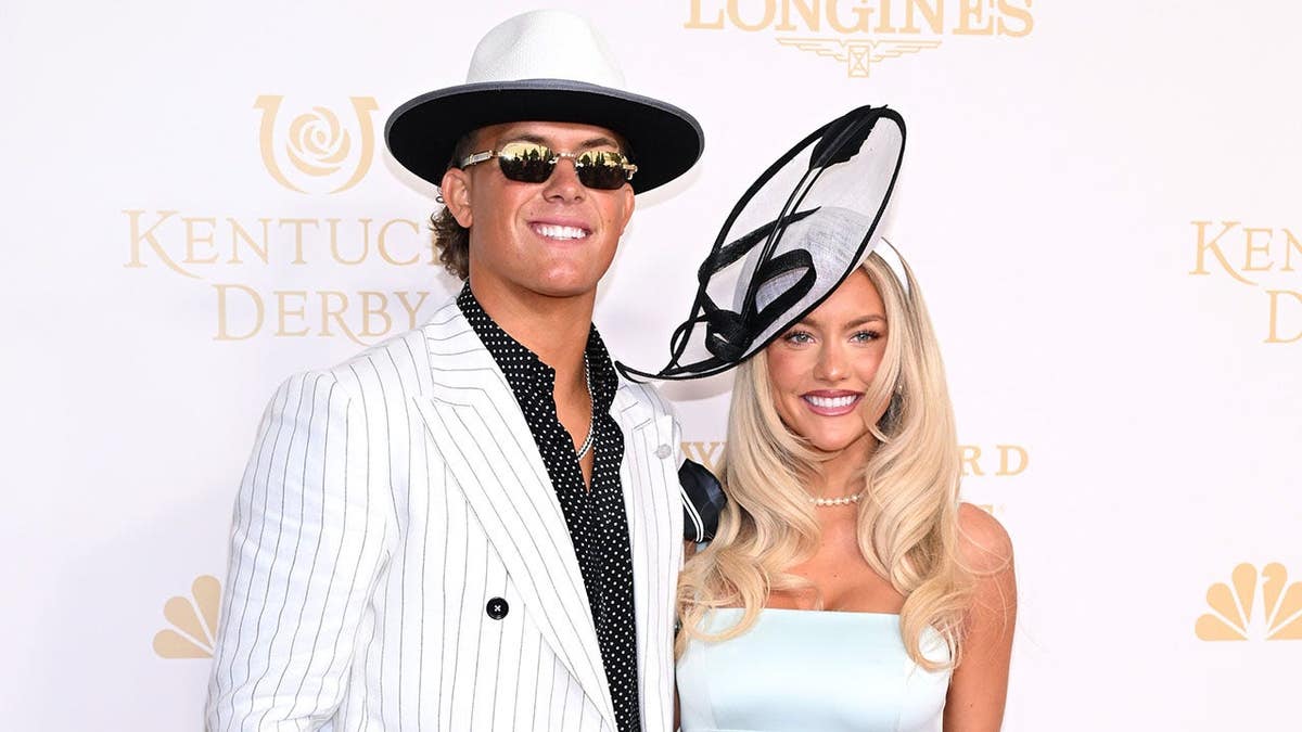 Jaxson Dart and Marissa Ayers standing together at Churchill Downs in Louisville, Kentucky