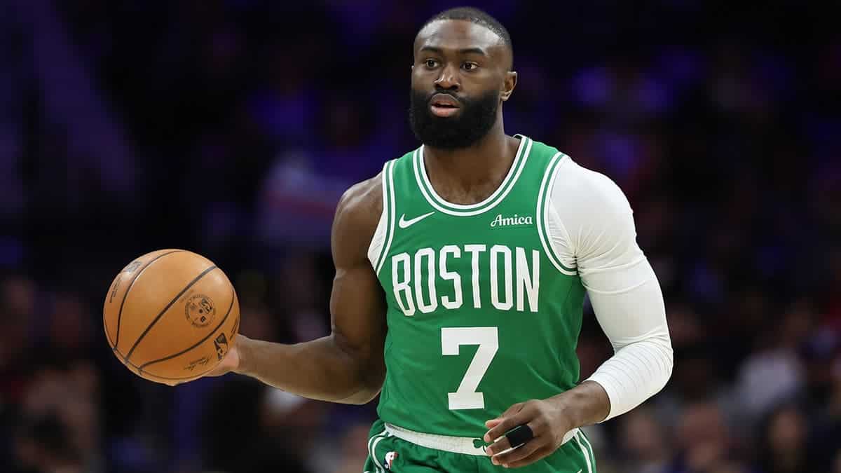 Boston Celtics guard Jaylen Brown dribbling basketball against Philadelphia 76ers at Xfinity Mobile Arena