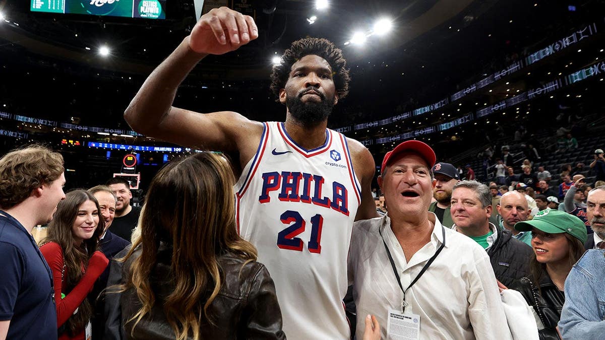 Joel Embiid celebrating on basketball court after victory