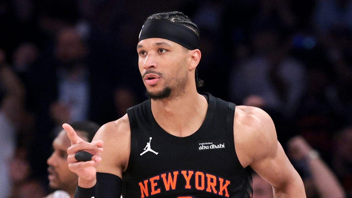 New York Knicks guard Josh Hart reacts after making a basket during a basketball game.