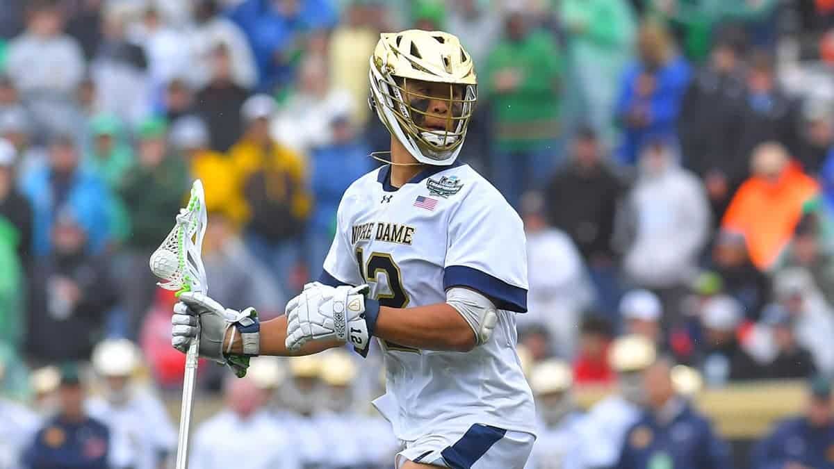 Josh Yago of Notre Dame Fighting Irish dodging Vincent Bolognino of Syracuse University Orange during lacrosse game