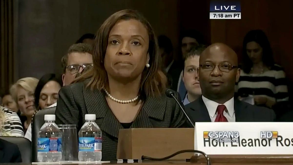 Eleanor Ross sitting behind a table