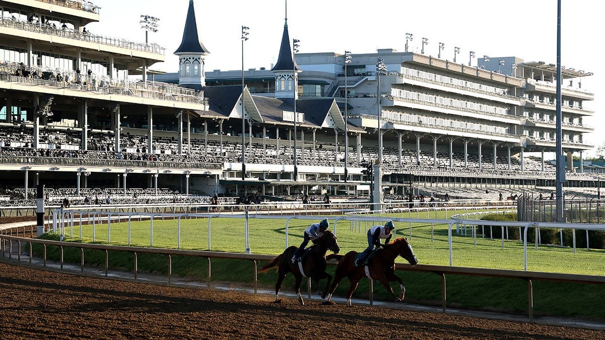 Horses running on the track during morning training at Churchill Downs