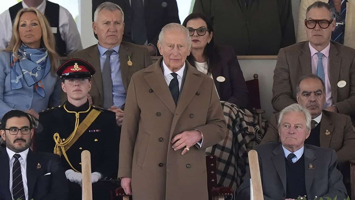 King Charles III standing as members of the King's Troop, Royal Horse Artillery perform a Royal salute in the Castle arena.