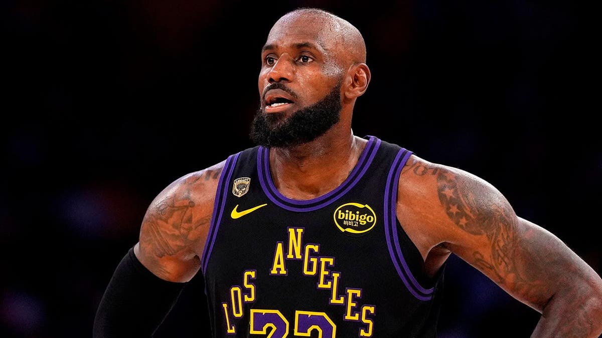 LeBron James standing on basketball court during NBA playoffs game.