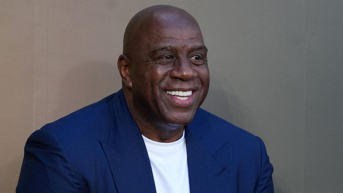Magic Johnson standing at unveiling of Pat Riley statue at Crypto.com Arena in Los Angeles