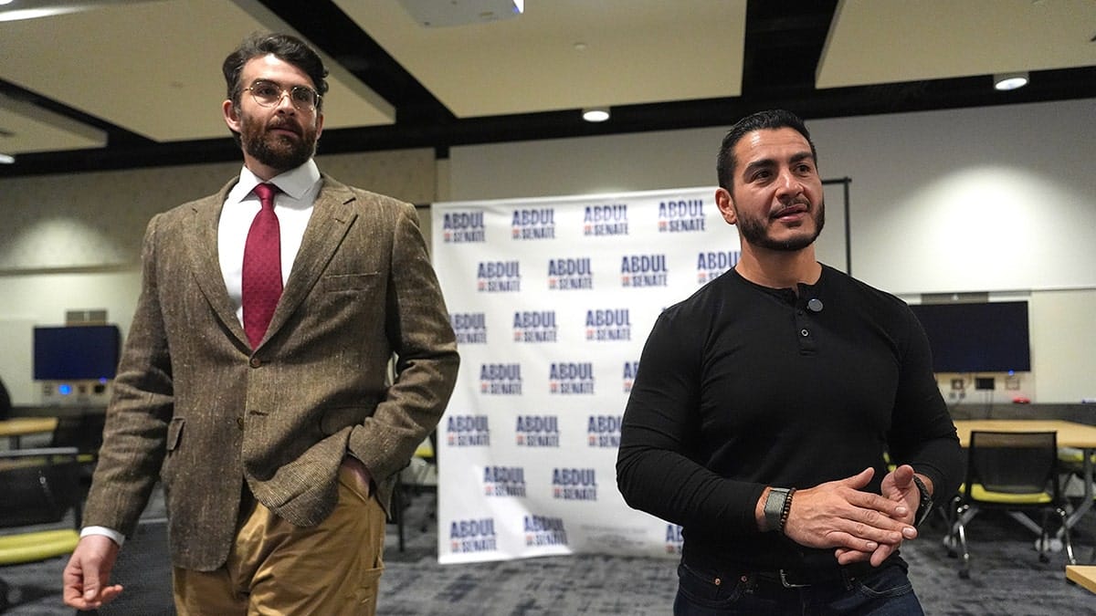 Hasan Piker listening to Abdul El-Sayed speaking in a green room