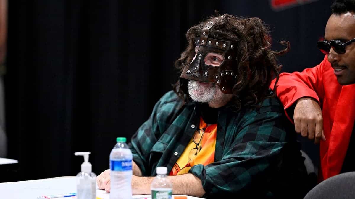 Mick Foley posing with a guest at New York Comic Con in New York City