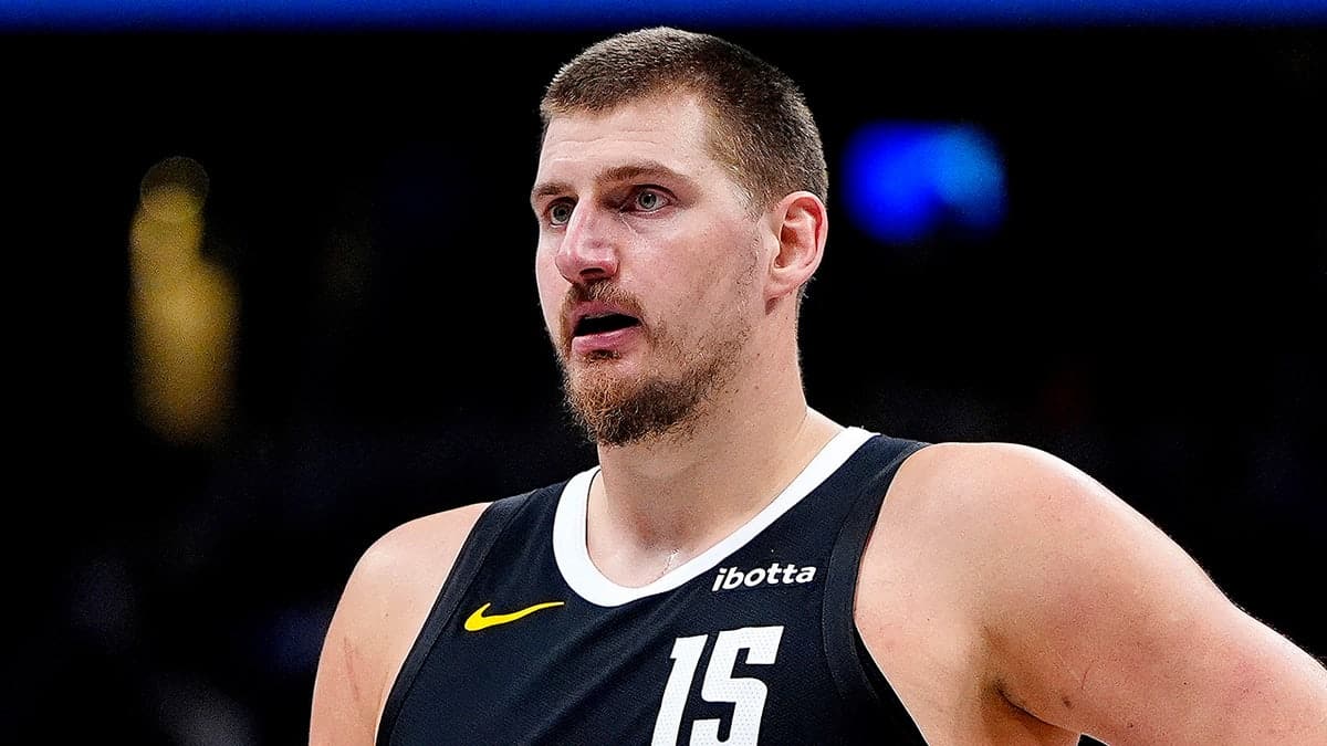 Nikola Jokic wearing number 15 jersey playing basketball at Ball Arena in Denver