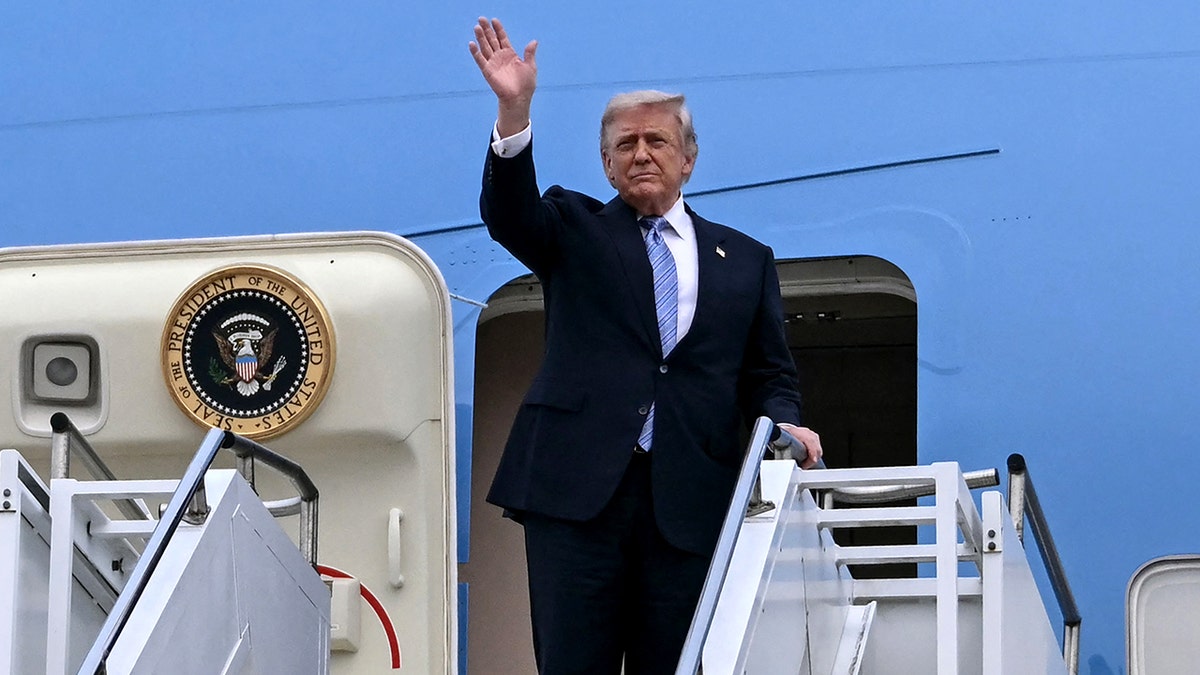 President Donald Trump waves on Air Force One.