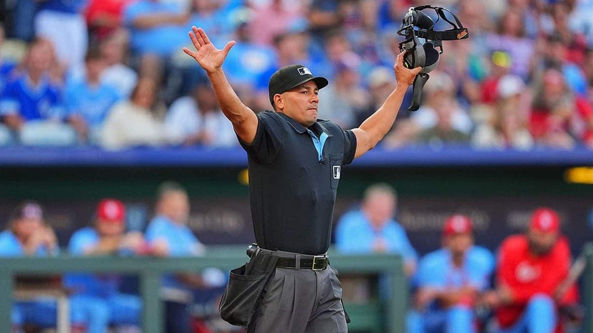 Umpire Roberto Ortiz signaling catchers interference during baseball game at Kauffman Stadium
