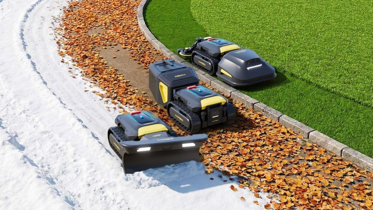 Three robot lawn mowers on a lawn