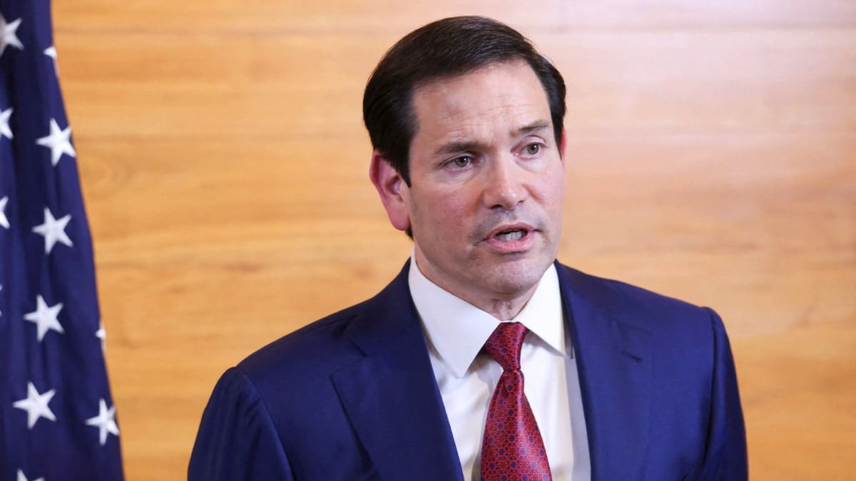 U.S. Secretary of State Marco Rubio speaking to reporters in an airport departure lounge
