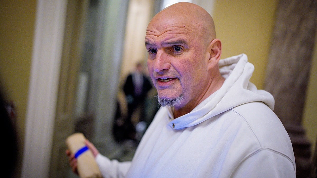 Sen. John Fetterman speaking to reporters outside the Senate Chamber on Capitol Hill