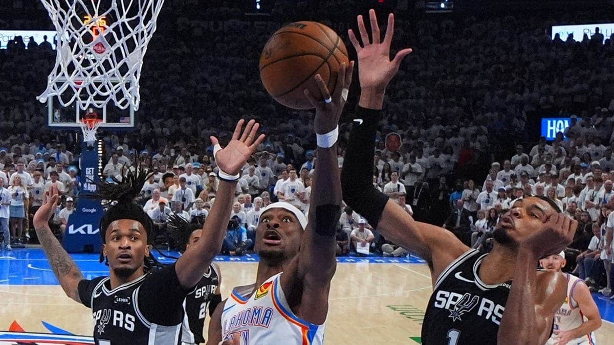 Oklahoma City Thunder guard Shai Gilgeous-Alexander shooting against San Antonio Spurs forward Victor Wembanyama