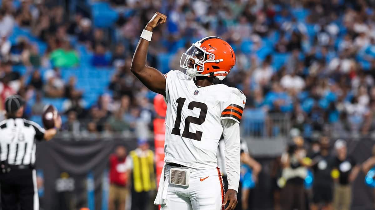 Shedeur Sanders celebrating a touchdown during an NFL preseason game at Bank of America Stadium
