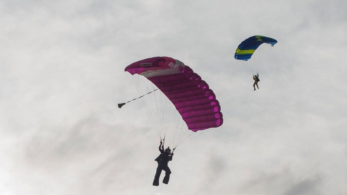 two skydivers with parachutes