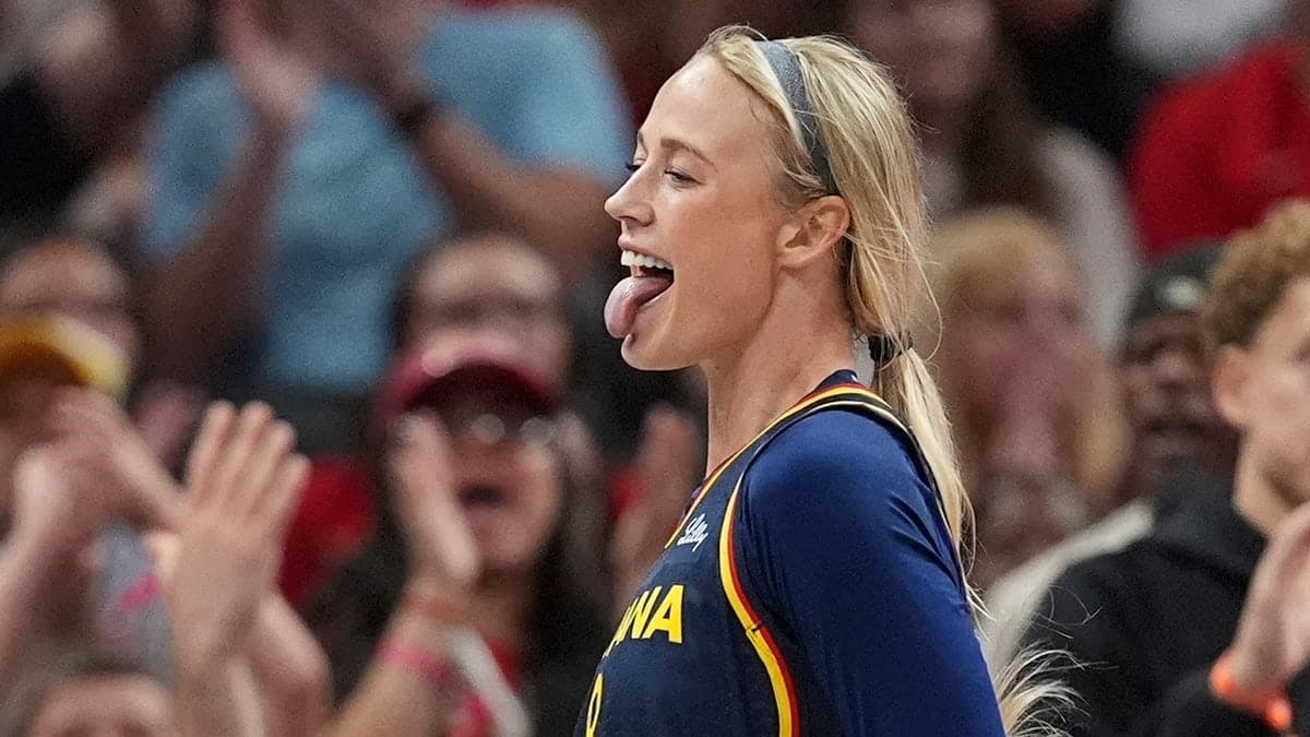 Indiana Fever's Sophie Cunningham reacts after hitting a shot and getting fouled in a basketball game