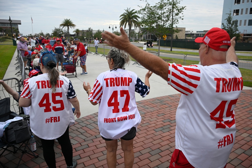 Supporters dance while waiting in line.