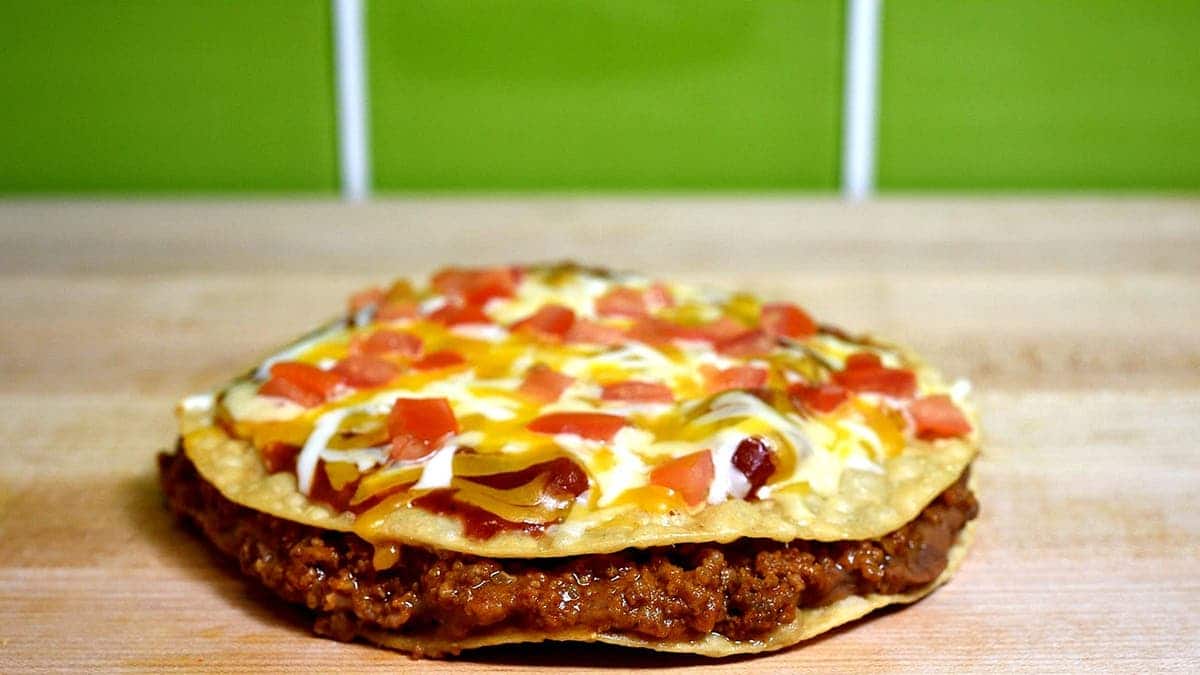 A Taco Bell Mexican pizza sits on a table.
