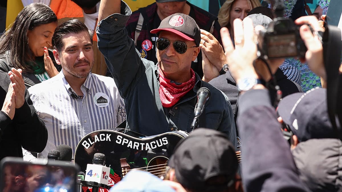 Tom Morello playing guitar at a protest