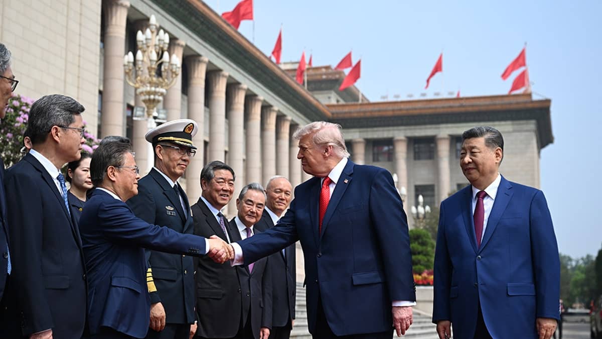 President Donald Trump and Chinese President Xi Jinping greeting officials at the Great Hall of the People