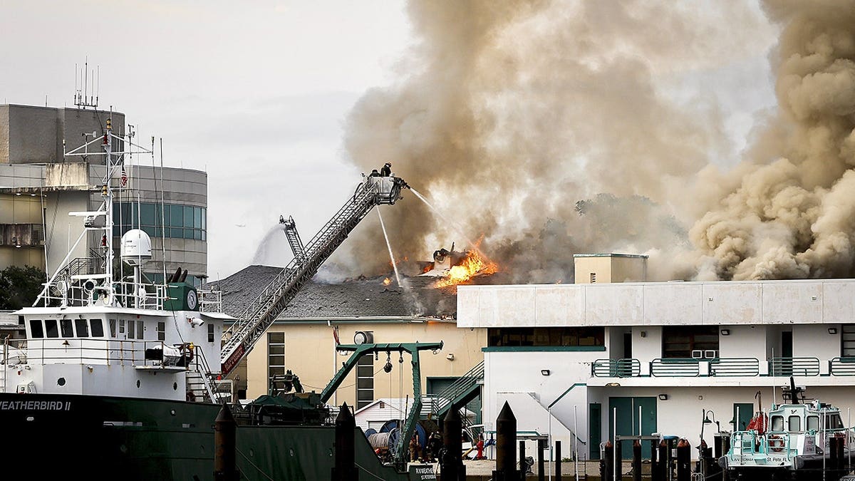 Firefighters extinguishing fire on University of South Florida campus in St. Petersburg