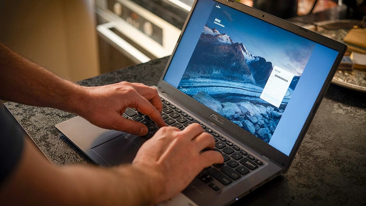 Person typing on a laptop.