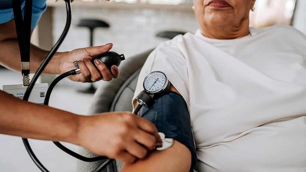 A woman has her blood pressure checked.
