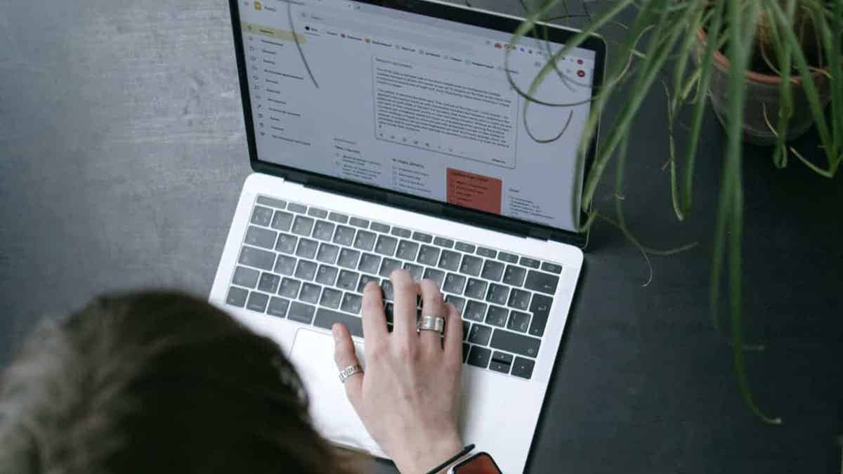A person typing on a laptop.