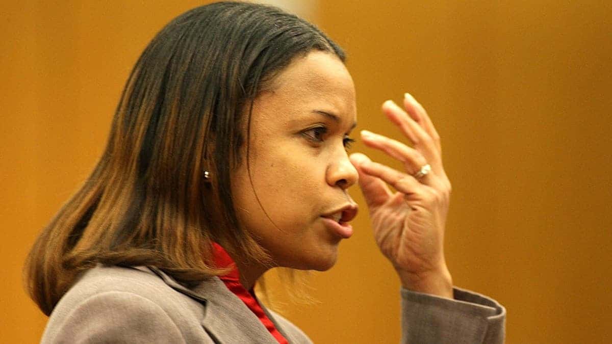 judge eleanor ross brushes her hair out of her face during testimony