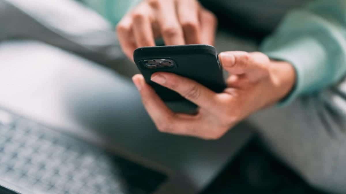 A woman using her iPhone while seated