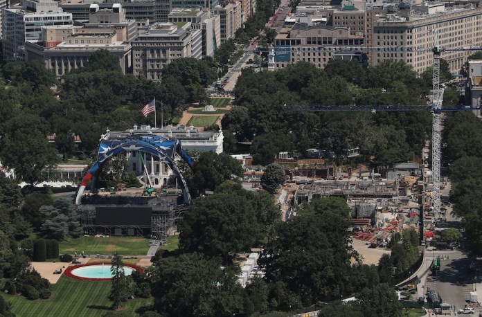 Workers continue building the cage for a future UFC fight on the South Lawn in front of the White House, Wednesday, June 3 2026, in Washington, as work continues on the construction of the ballroom, right, as seen from the Washington Monument. (AP Photo/Rahmat Gul)