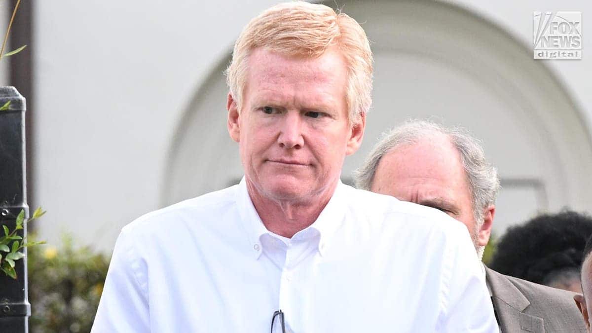 Alex Murdaugh wearing a white button-down shirt looking to the side while being led out of a courthouse