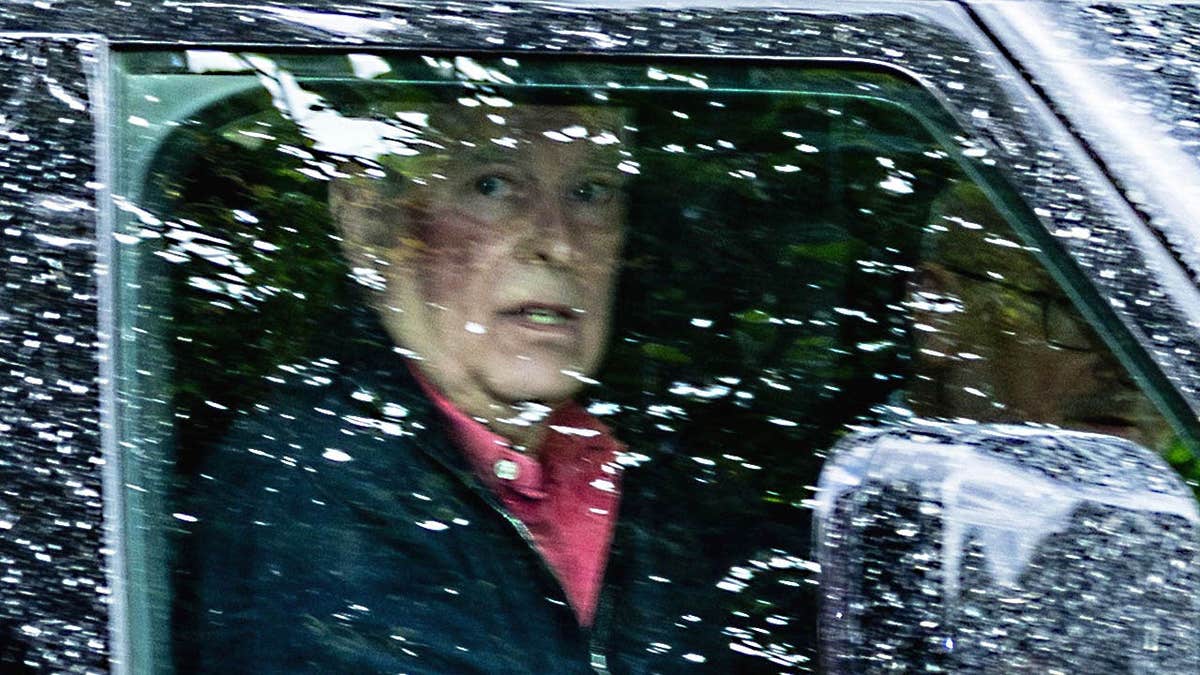 Former Prince Andrew looking shocked in his car with a bruise.