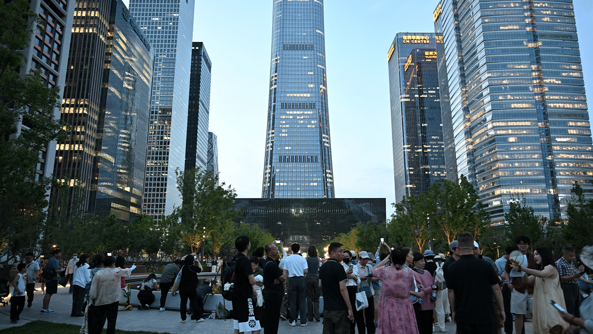 People gather near the CITIC Tower in Beijing on June 26, 2026, after an eyewitness reported plane debris at the base of Beijing's tallest building.
