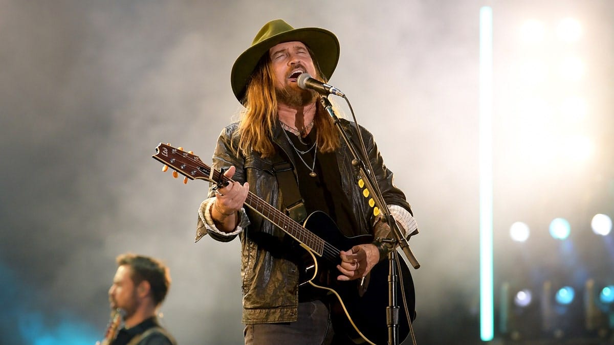 Billy Ray Cyrus performing on stage