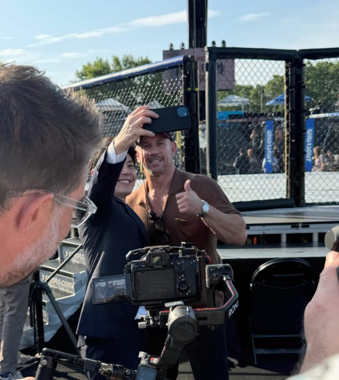 Lightweight fighter Michael Chandler poses with a member from the Japanese media. (Judith Y. Kim/Washington Examiner)