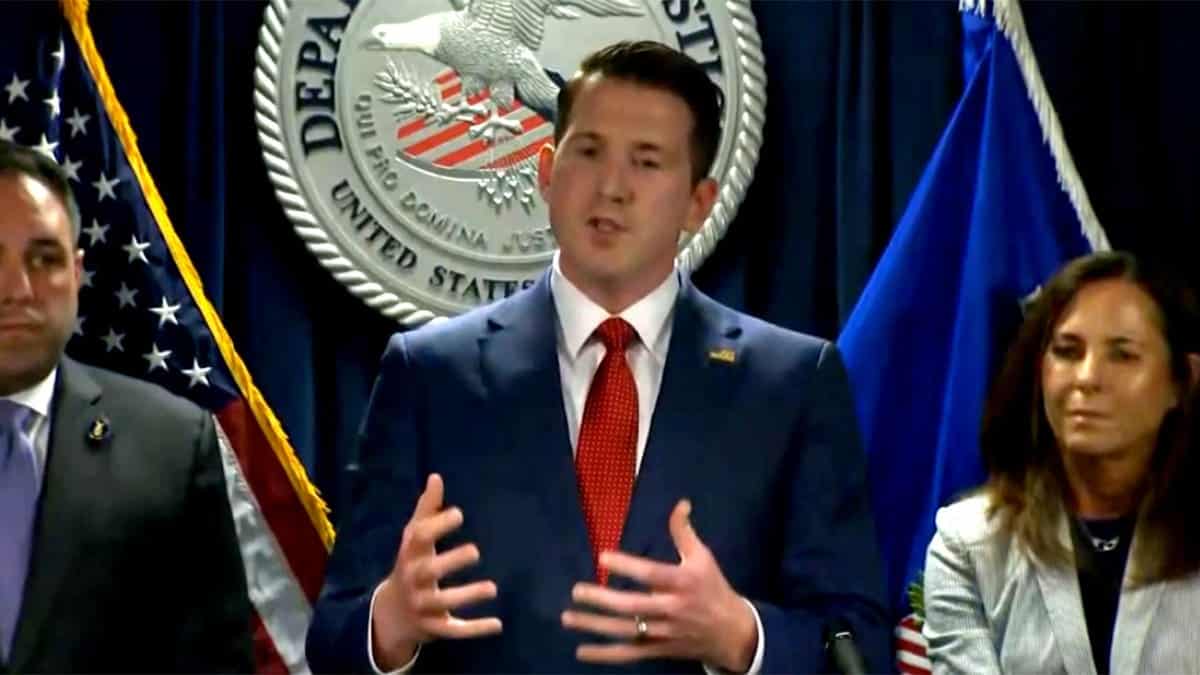 Acting Assistant Attorney General Colin MacDonald speaking during a press conference