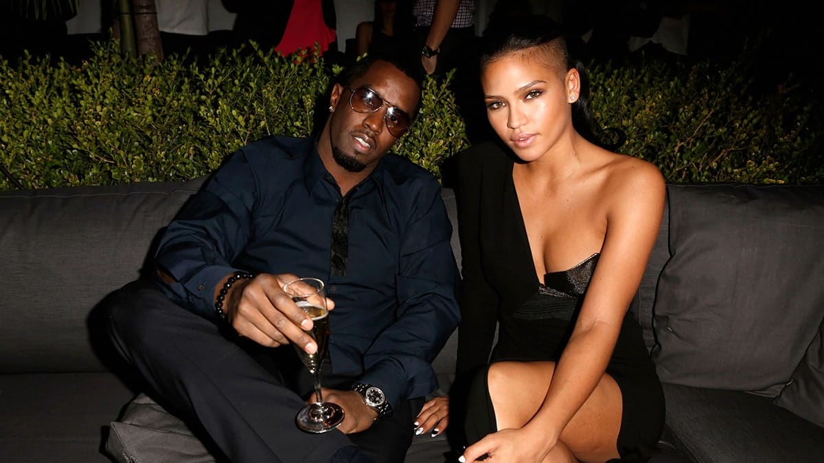 Cassie and Sean Combs sitting on a couch at a Hollywood event