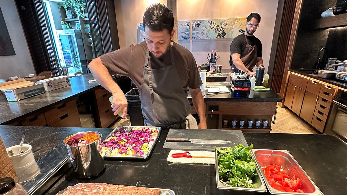 Chef Osmel Gonzalez working to prepare meal at Emelina in West Palm Beach, Florida