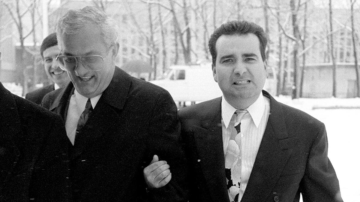 Lewis Kasman walks with John Gotti's brother, Peter.