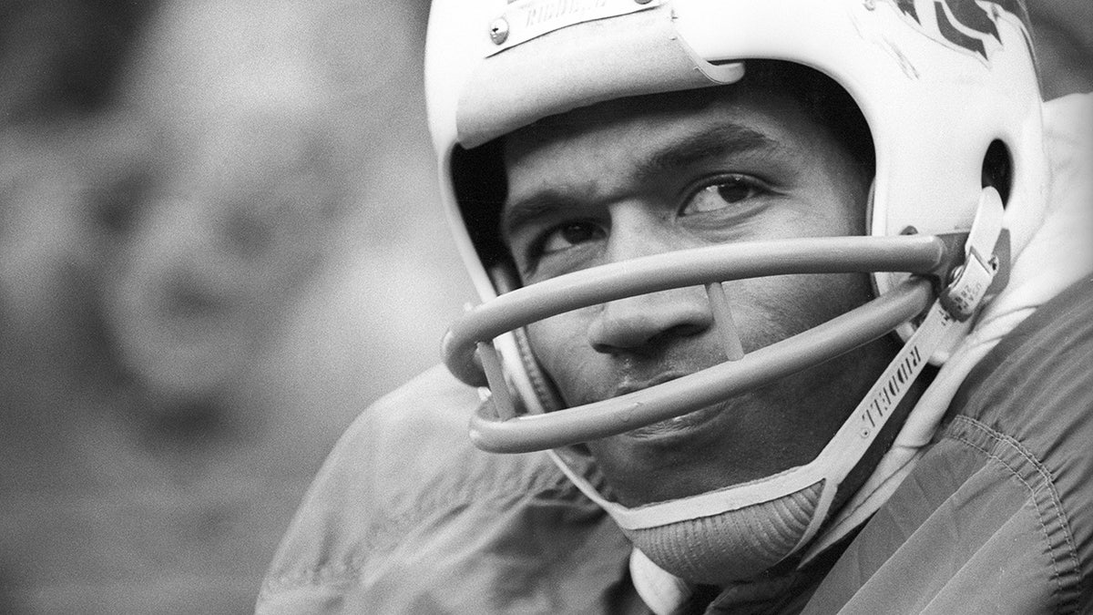 O.J. Simpson running with football during NFL playoff game at Three Rivers Stadium