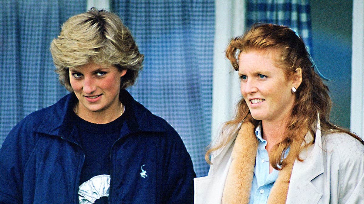 Princess Diana and Sarah Ferguson standing together on a palace balcony looking serious.
