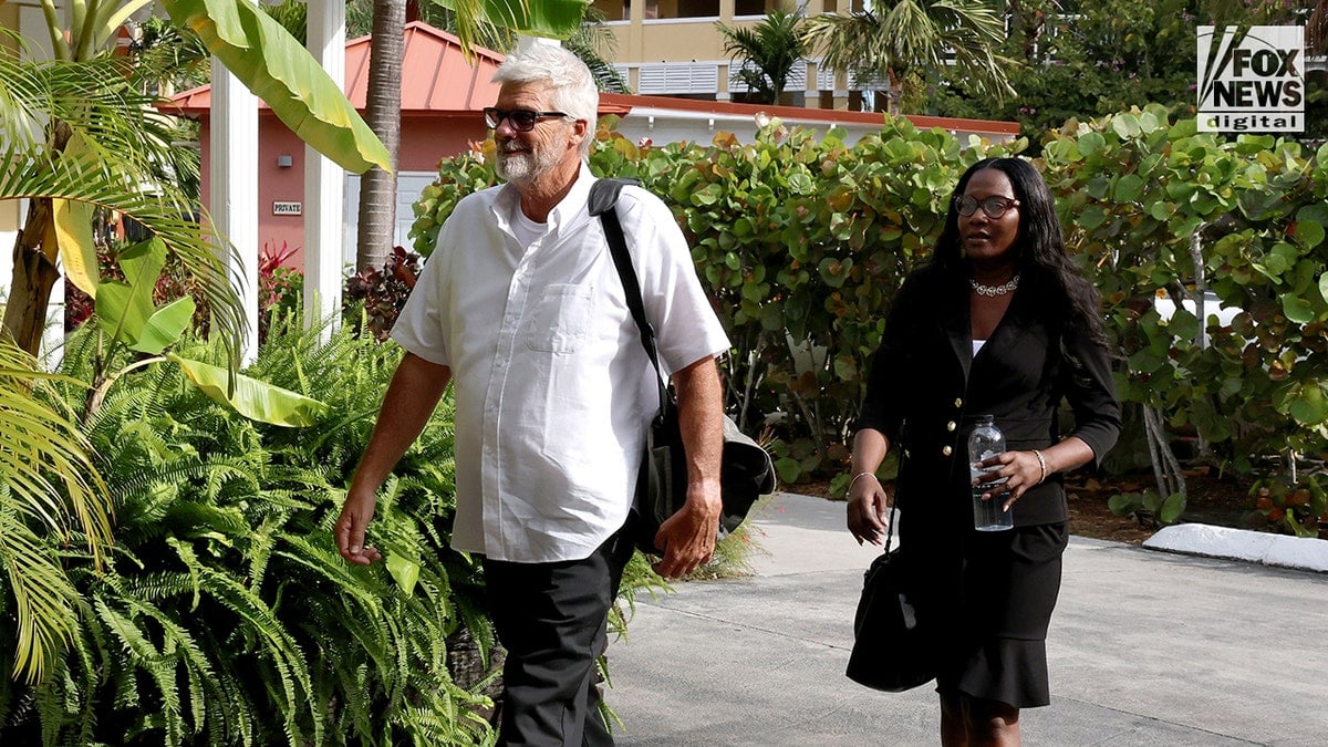 Brian Hooker leaving hotel with lawyer Terell A. Butler in Freeport, The Bahamas