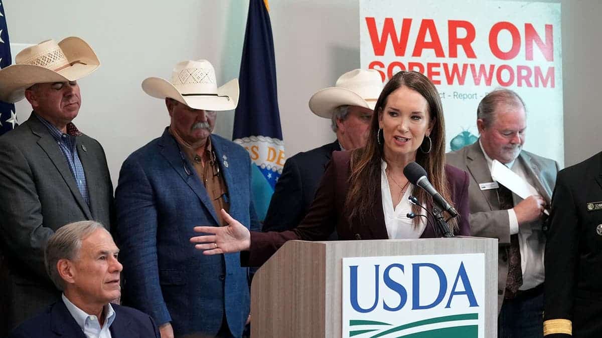 Brooke Rollins speaks in front of ranchers during a news conference with Greg Abbott.