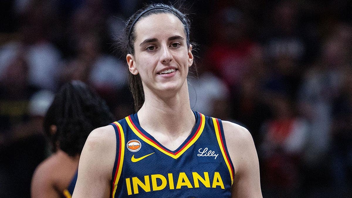 Indiana Fever guard Caitlin Clark dribbling basketball during game at Gainbridge Fieldhouse